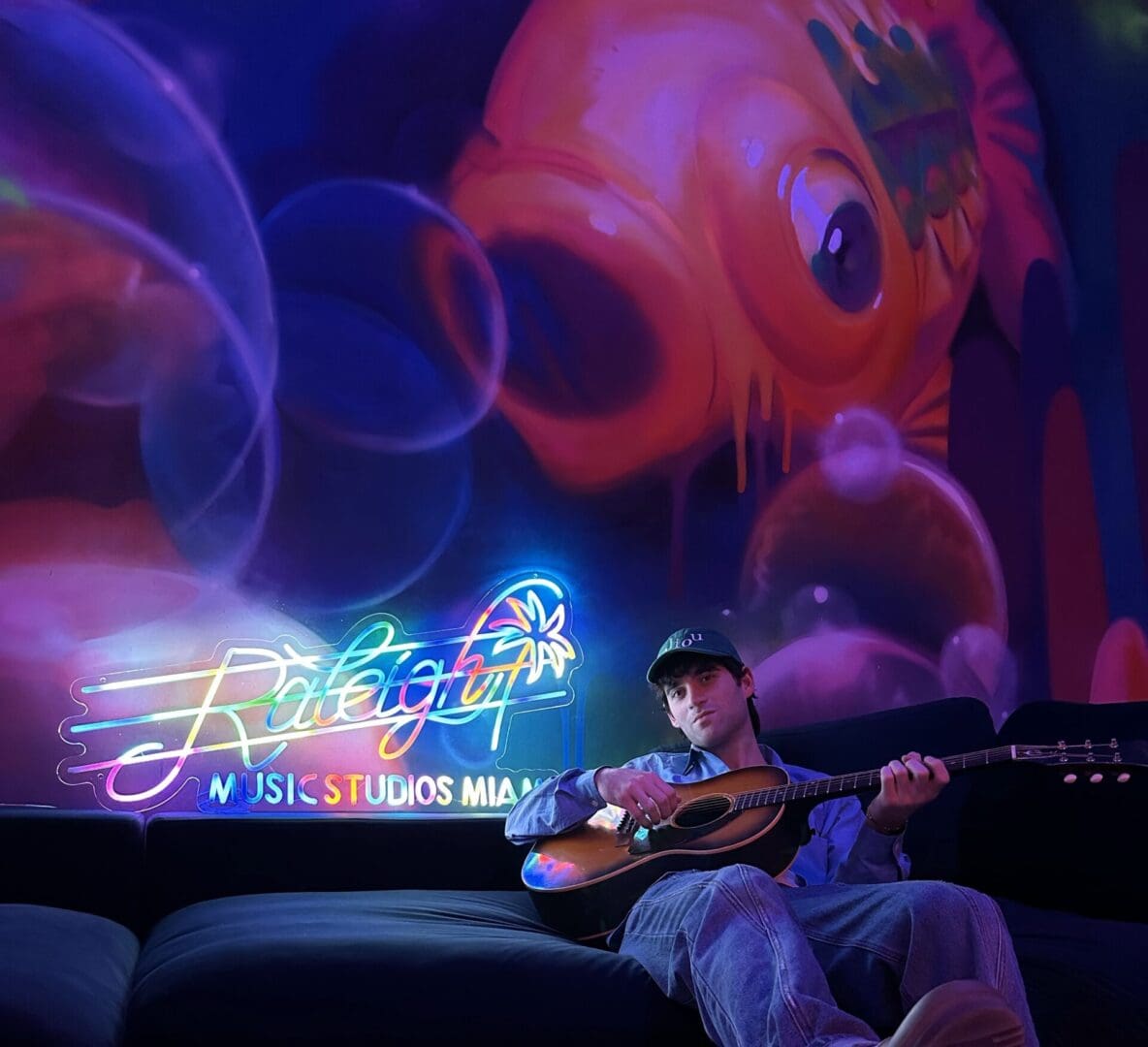 Man playing guitar at Raleigh Music Studios Miami.