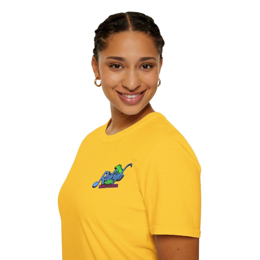 Woman smiling in yellow Raleigh Music Studios tee.