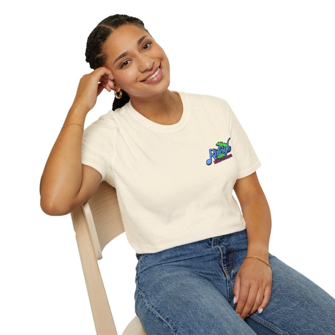 Woman smiling, wearing Raleigh Music Hall tee.