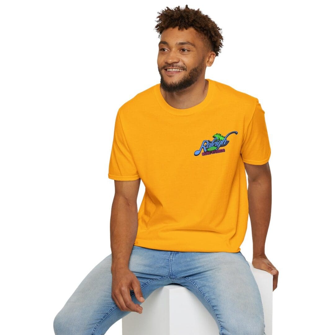 Man in gold T-shirt with Raleigh Music Studios logo.