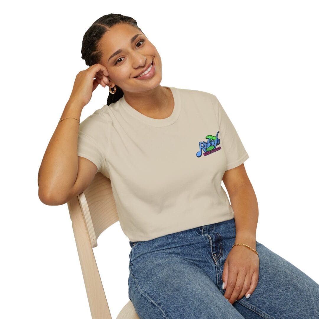 Woman smiling, wearing beige Raleigh t-shirt.