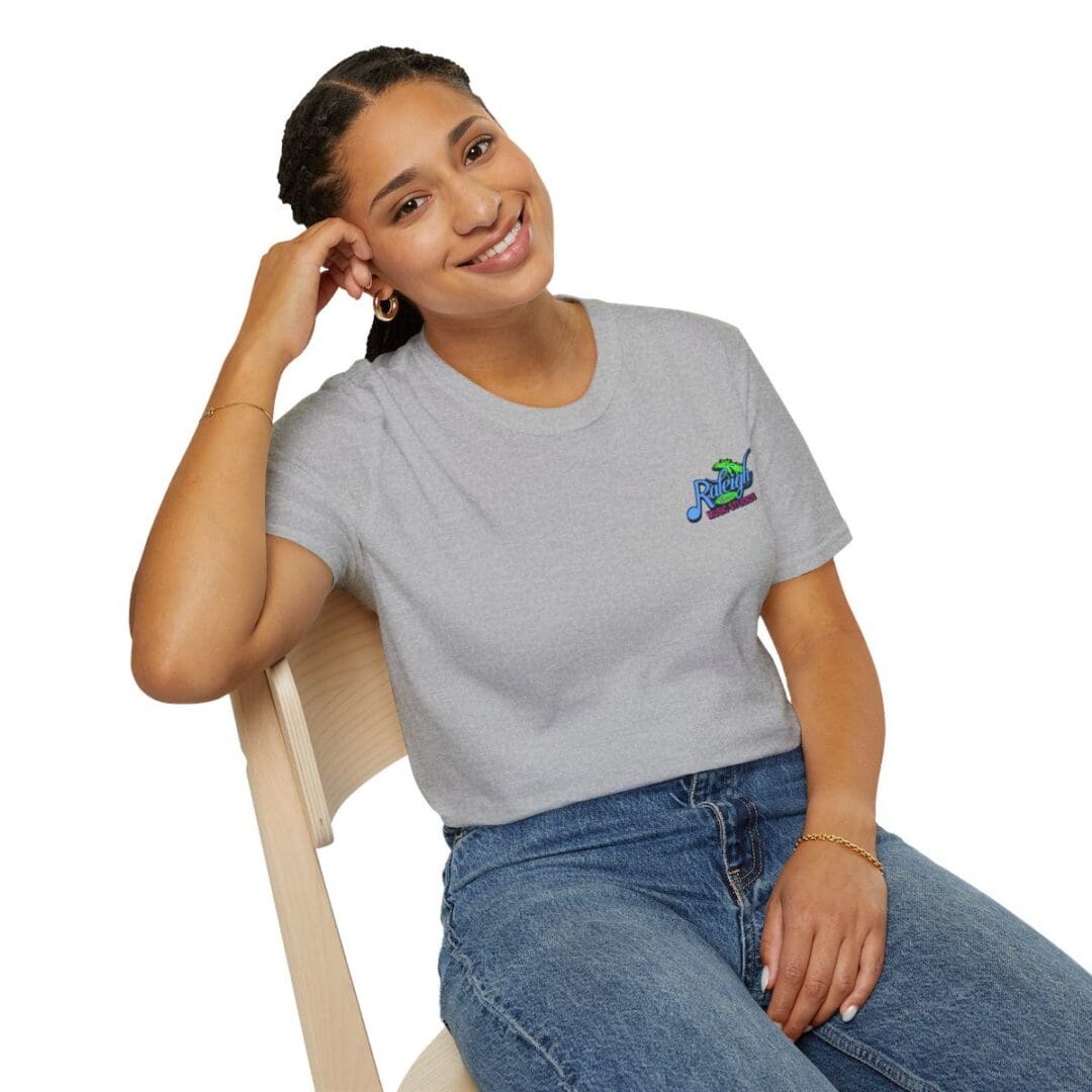 Woman smiling in gray Rugby t-shirt.
