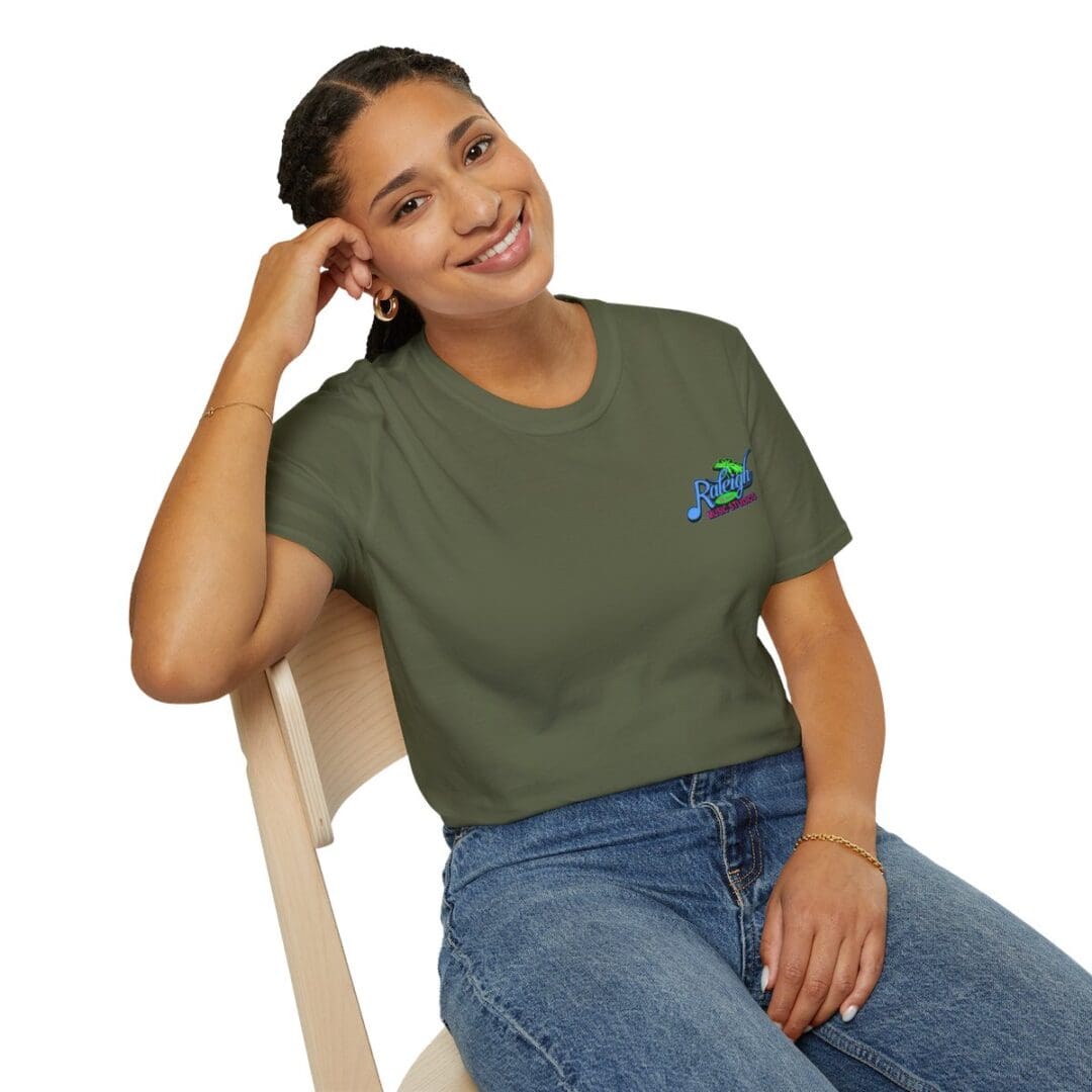 Woman in olive green t-shirt with logo.