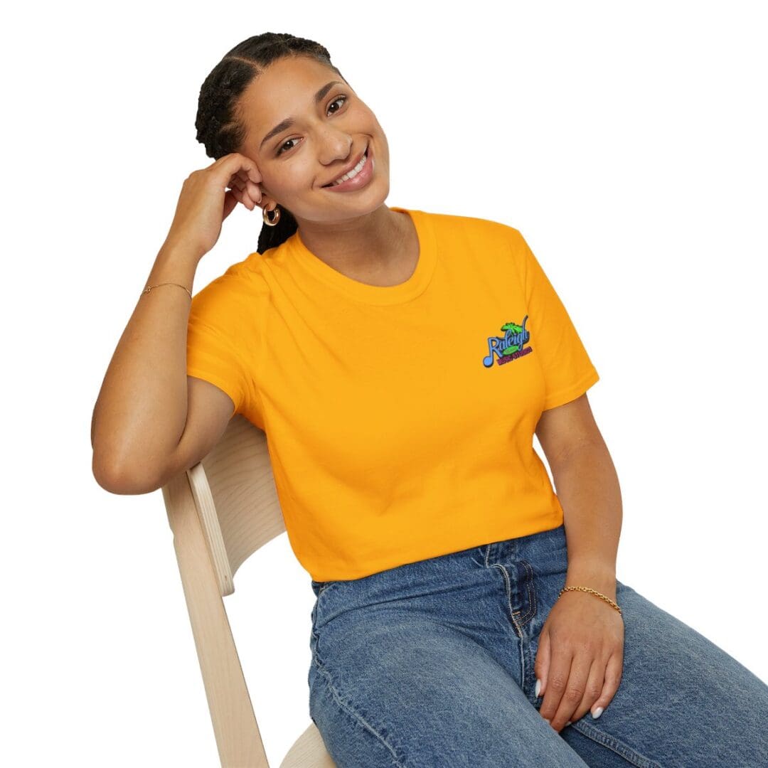Woman smiling in yellow Reggae shirt.