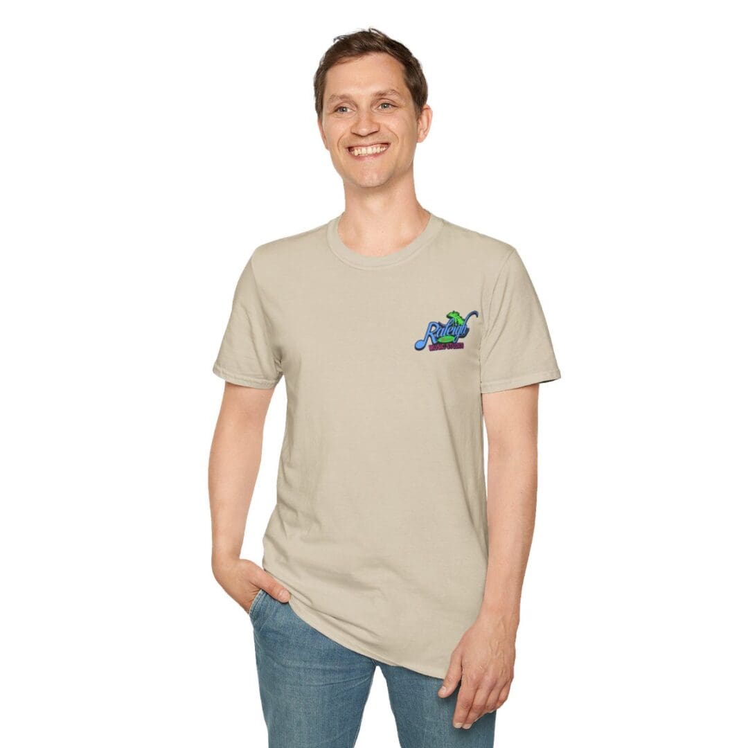 Man in beige tee with Raleigh Watersports logo.