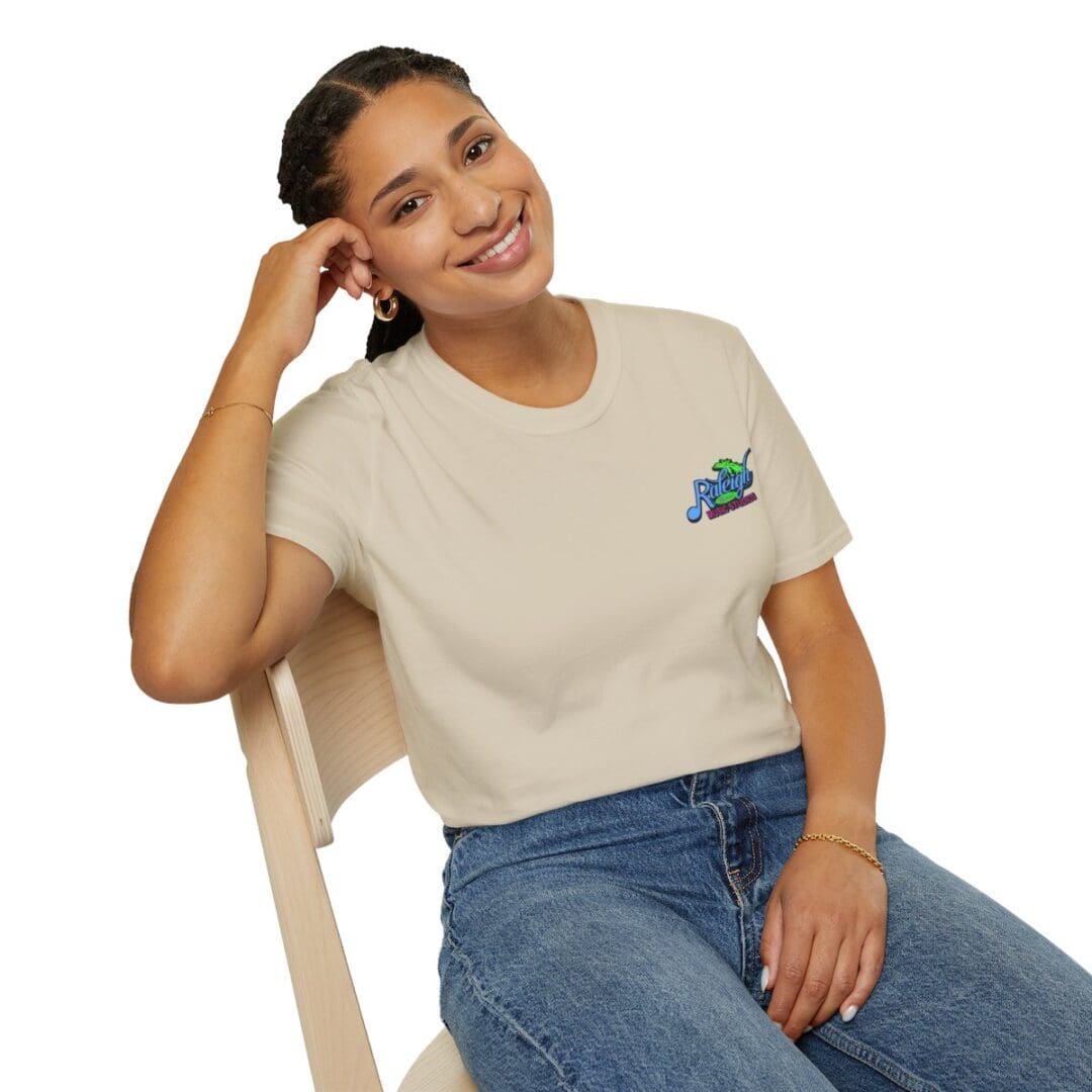 Smiling woman wearing beige t-shirt with logo.